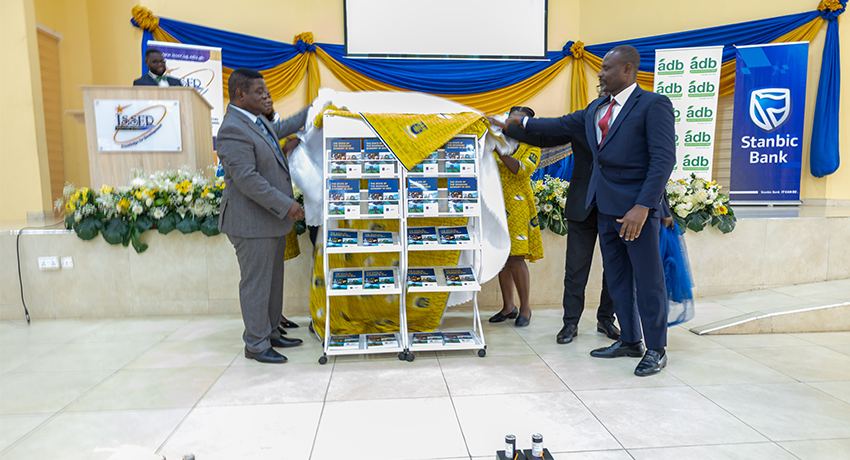 The Chairman, Prof. Quartey, and Prof. Ofori unveil SGER 2022. With them are the heads of division at ISSER: Prof. Isaac Osei-Akoto, Head of the Economics Division; Prof. Charles Ackah, Head of Statistics and Survey Division and Dr. Martha Awo, Head of the Social Division.