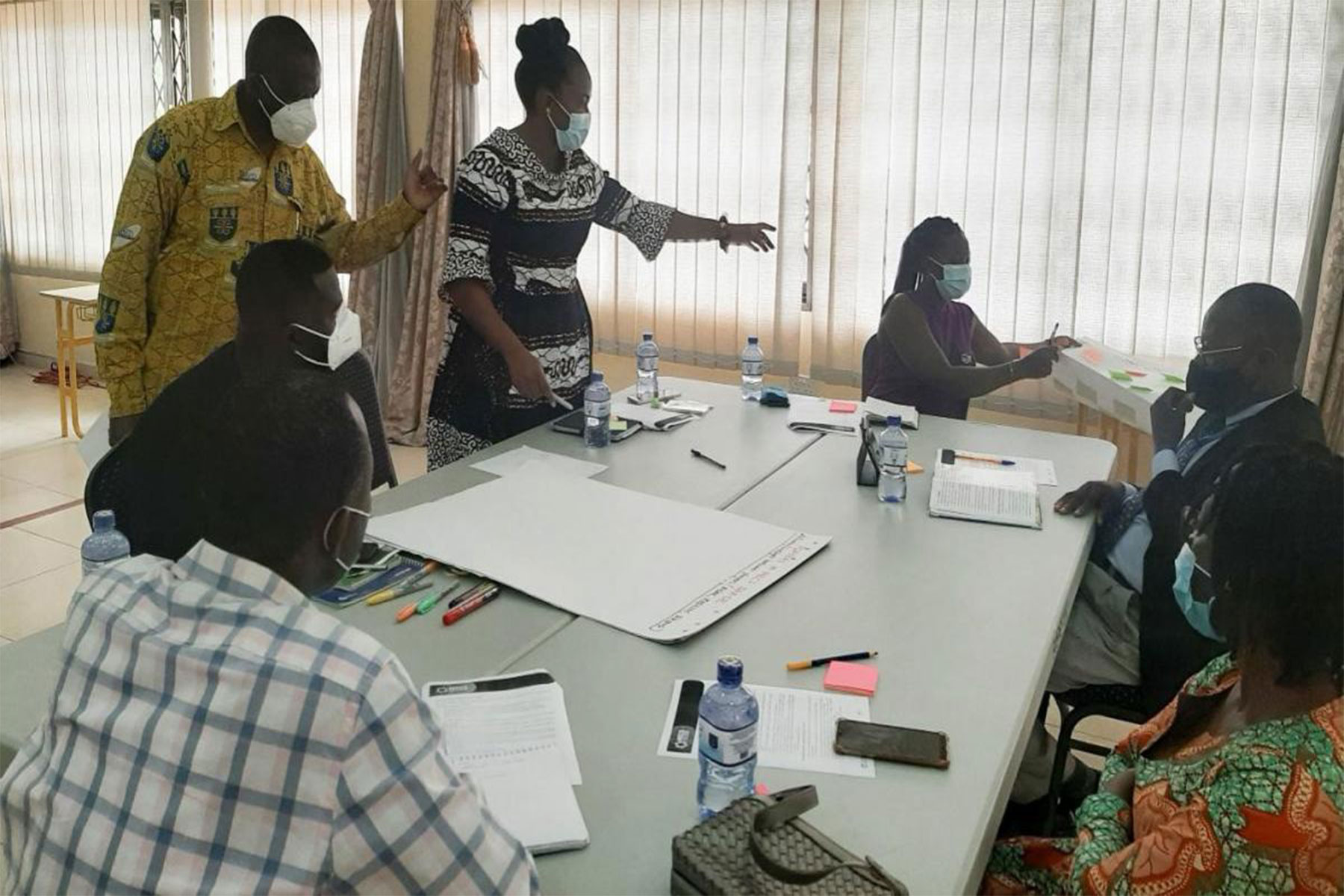 Dr Bawakyillenuo (PI, standing 1st right) and Dr Aba Crentsil (Co-PI, standing 2nd right) facilitate group-level work